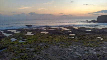 sunset over the sea, a scenic view of a beach in late afternoon