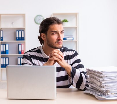 Young employee feeling like prisoner at work