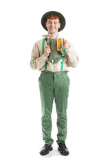 Young man in traditional German clothes with beer and sausage on white background