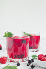 Healthy summer drinks with raspberry, black currant and mint. Copy space.