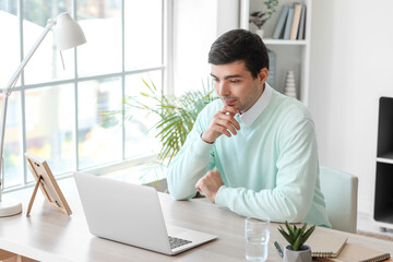 Young man having job interview online at home