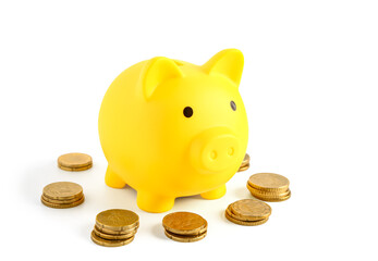 Yellow piggy bank with coins isolated on white background