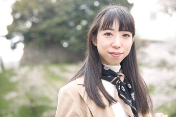 A portrait of Japanese woman behind cherry blossom in Tokyo copyspace