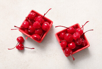 Bowls of tasty maraschino cherries on light background - obrazy, fototapety, plakaty
