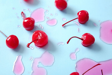 Tasty maraschino cherries on blue background - obrazy, fototapety, plakaty