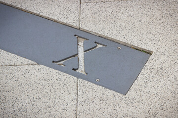 Roman numerical number ten made of stone tiles on street