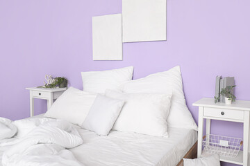Comfortable bed with white pillows in interior of stylish bedroom