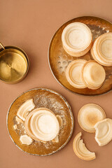 Plates with homemade tartlets on brown background