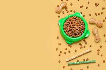 Composition with dry dog food and treats on color background