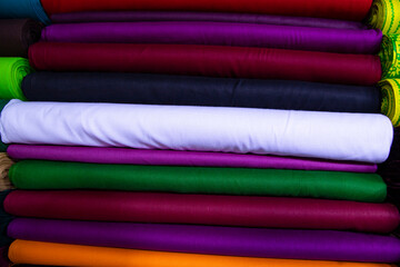 Artistic variety shade tone colors Textile Fabrics stacked on retail Shop Shelf to sale