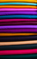 Artistic variety shade tone colors Textile Fabrics stacked on retail Shop Shelf to sale