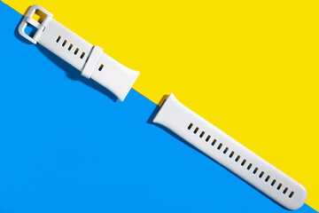 plastic watch strap on a yellow-blue background, abstraction
