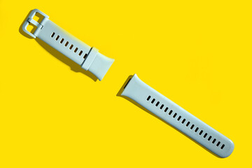 plastic watch strap on a yellow background, abstraction