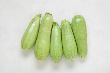 Fresh green zucchini on light background