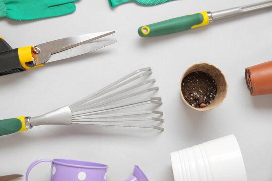 Different gardening tools on grey background