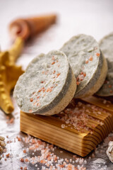 Natural soap with sea salt on a wooden soap dish, shells and a starfish. Organic summer soap, immersing in the marine atmosphere