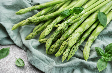 Fresh green asparagus on  concrete background.