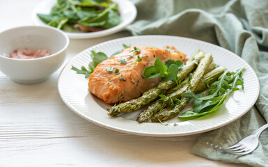 Baked Delicious salmon, green asparagus on  plate