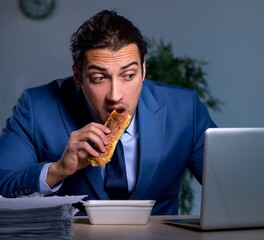 Hungry employee working late in the office