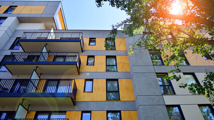 A modern residential building in the vicinity of trees. Ecology and green living in city, urban...