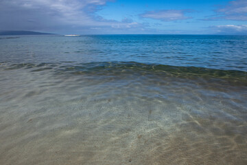 Tropical blue ocean in Hawaii. Summer sea in clean and clear water from surface for background. Waves concept design.