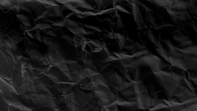 Abstract art background animation black crumpled paper. Realistic cartoon wrinkled surface texture in modern trendy stop motion style.
