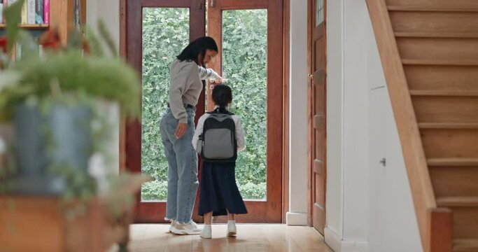 Mother, kid and ready for school in hallway or morning with routine to travel with backpack. Mom, helping and girl student with leaving home for education at front door with uniform or preparation.
