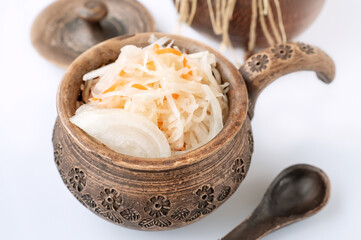 sauerkraut in clay eco-friendly dishes. Cooking homemade fermented food, the concept of healthy home nutrition