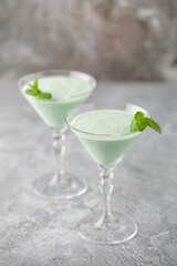 Grasshopper cocktail  from New Orleans, with green mint liqueur, chocolate liqueur and cream in martini glass.