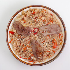 Fried rice with beef and vegetables isolated on white background. Traditional chinese food - fried rice with egg and beef in ceramic bowl.