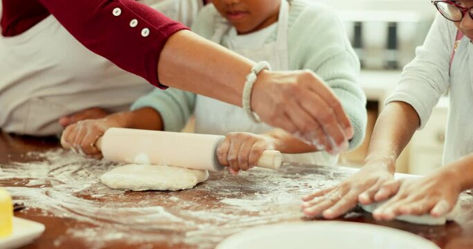 Dough, hands and closeup of family baking in the kitchen for cookies or dessert for sweet treat. Ingredients, equipment and zoom of girl children making cookies or biscuits with mother in family home