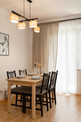 Dining table and chairs in the room. The interior of the apartment.