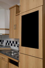 Black writing board on the built-in refrigerator in the elegantly decorated kitchen