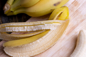Peeled old ripe banana on the board