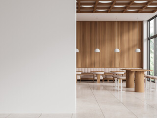 Stylish cafe interior with seats and window, dining zone and table. Mockup wall