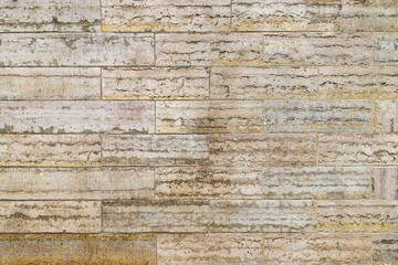 Fototapeta premium Texture of an old beige stone wall made of limestone blocks as an architectural background