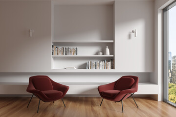 White living room interior with armchairs and bookshelves