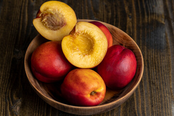 Nectarines folded in a wooden bowl