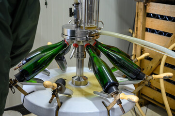 Disgorgement and adding sweet liquor procedure, traditional making champagne sparkling wine from...