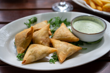 Traditional Middle East snack fried stuffed samosa pie with vegetables served with mint sauce
