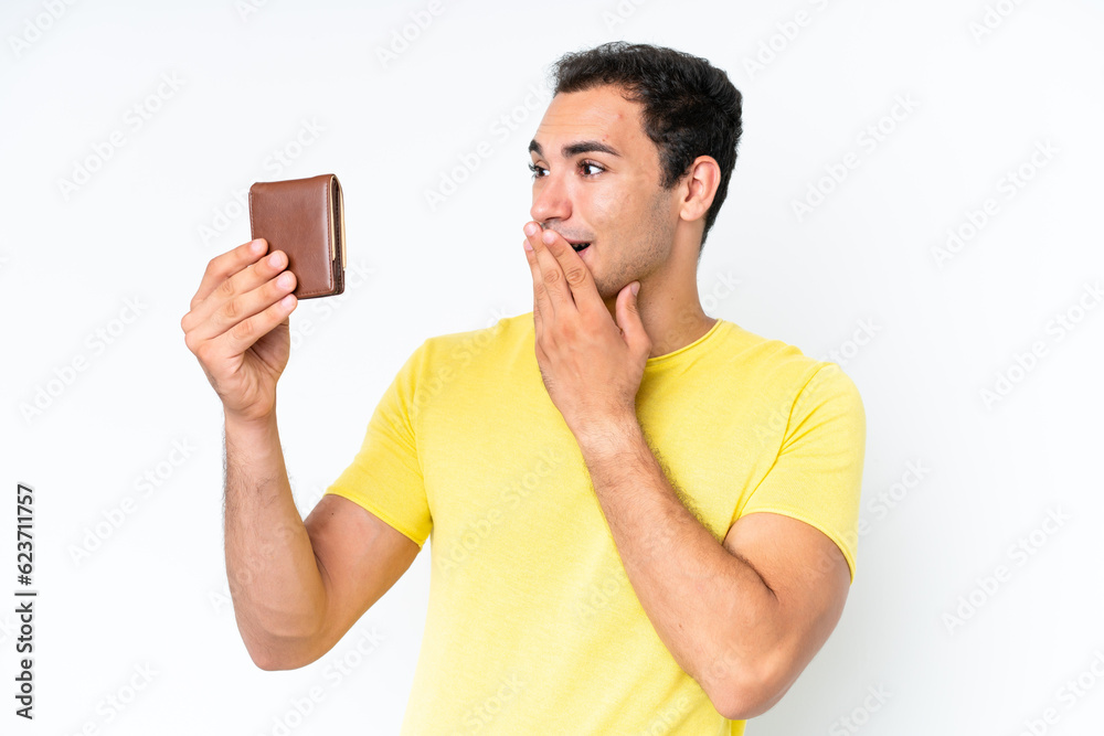 Sticker Young caucasian man holding a wallet isolated on white background with surprise and shocked facial expression