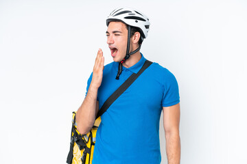 Young caucasian man with thermal backpack isolated on white background yawning and covering wide open mouth with hand