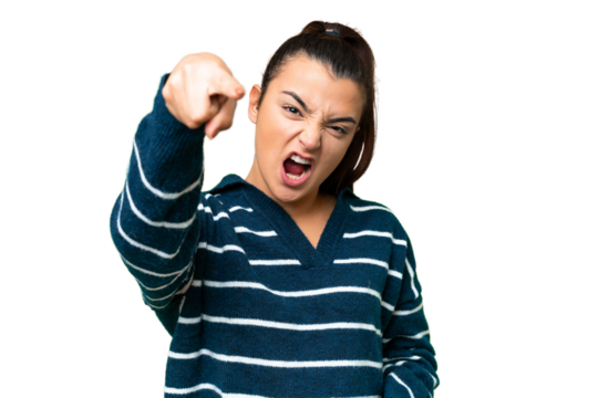 Young beauty woman over isolated chroma key background frustrated and pointing to the front