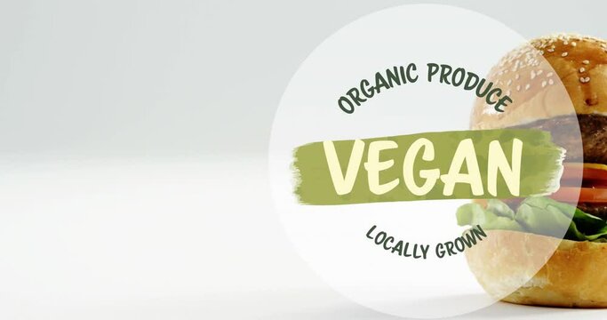 Animation of vegan food text over vegan burger on wooden board