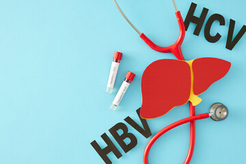 Hepatitis Day and awareness about infections. Top view photo of liver symbol, HBV, HCV...