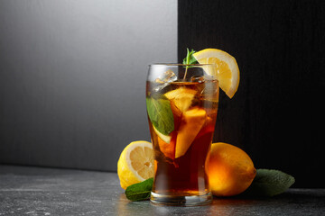 Iced tea or a summer refreshing drink with ice, mint, and lemon.