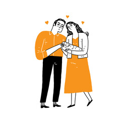 Young smiling parents mother and father family standing and holding small toddler infant newborn baby in hands feeling love and happiness.