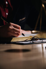 Justice and law concept.Male judge in a courtroom with the gavel, working with, computer and docking keyboard, eyeglasses, on table in morning light