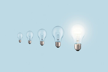Creative light bulbs loading process and one glowing light bulb on a blue background. Creative...