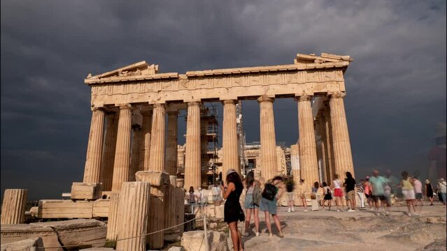 Time lapse of Acropolis in Athens with dramatic sky and visitors